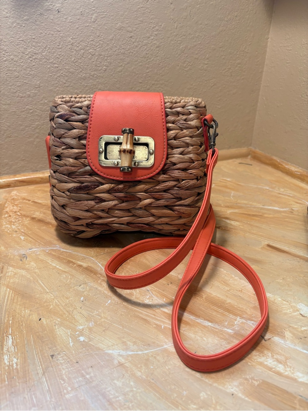 Woven Straw Crossbody with Coral Accent and Turn-Lock Closure